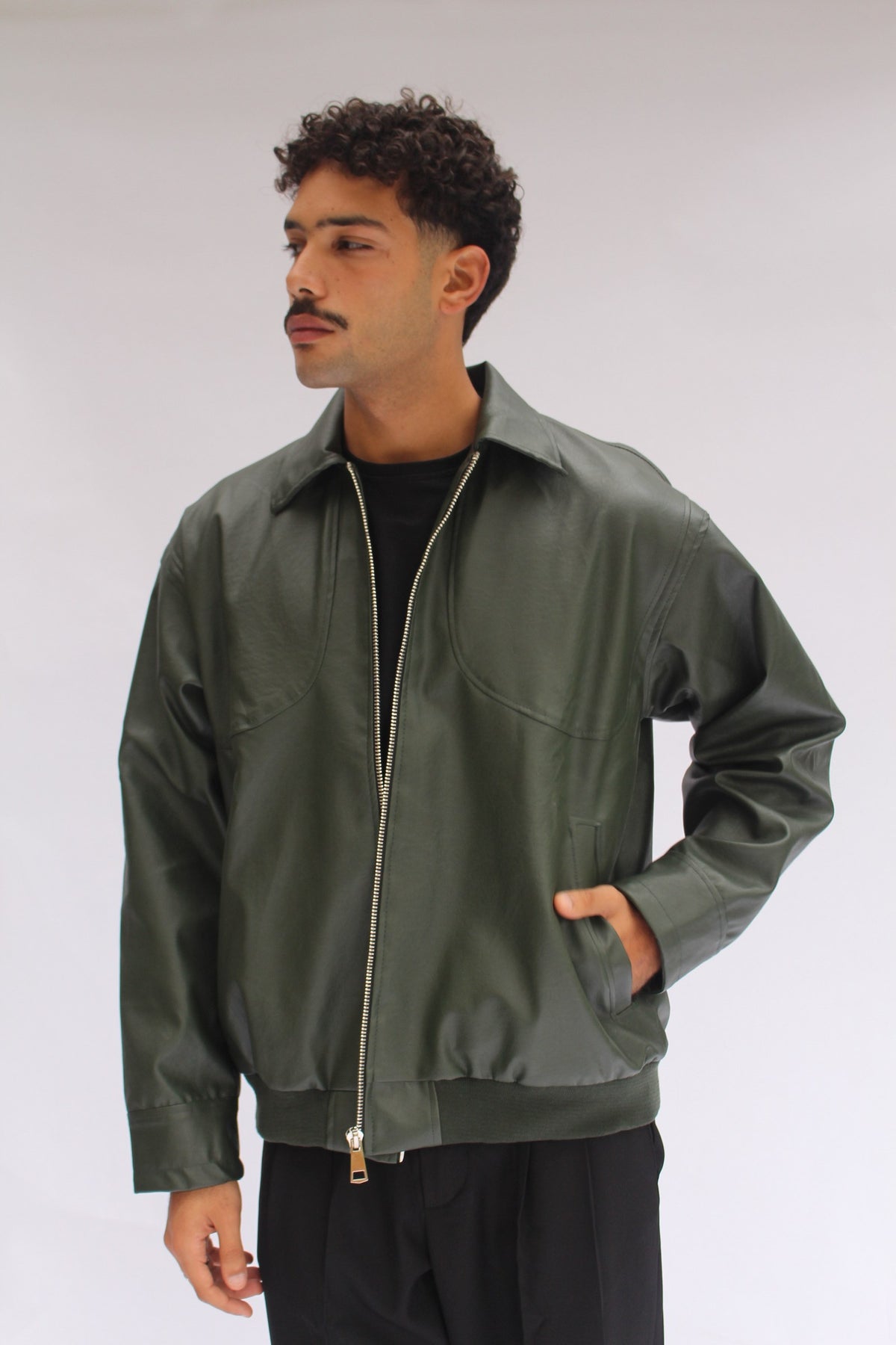 Green Leather Jacket worn open over a black tee